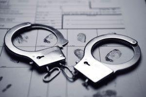 Handcuffs on top of a fingerprint form.