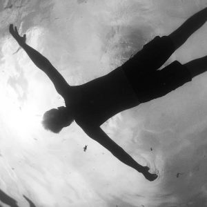 Swimmer floating on his back.